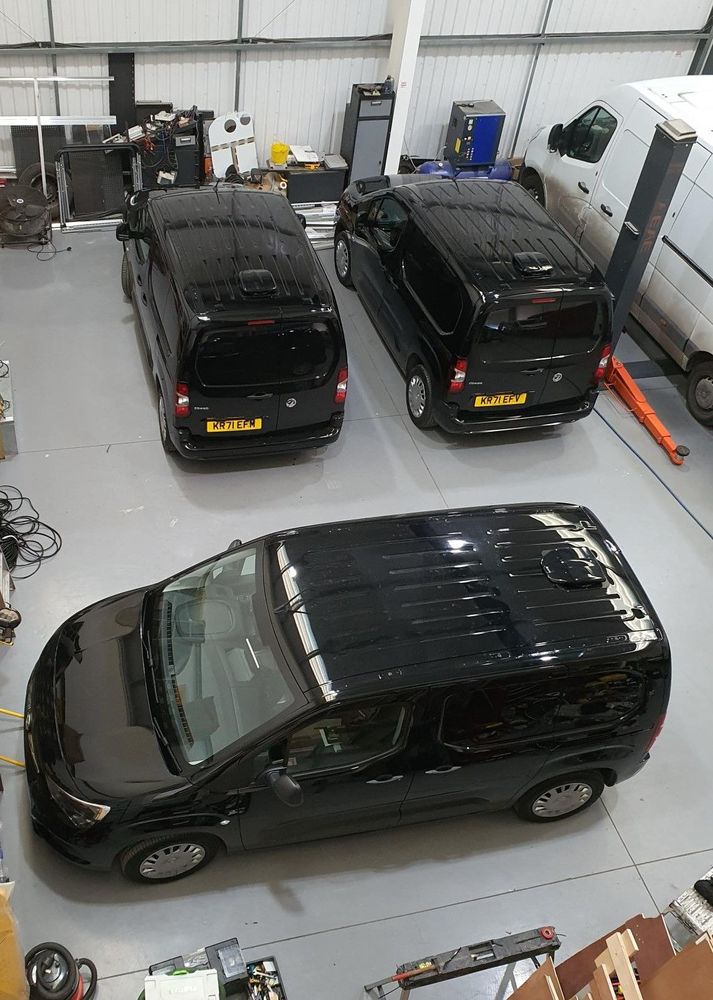 Two fleet cars parked outside the unit