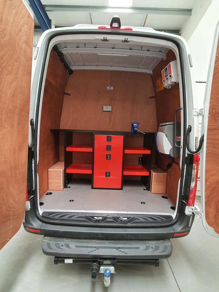 Red drawer units and racking installed inside a van