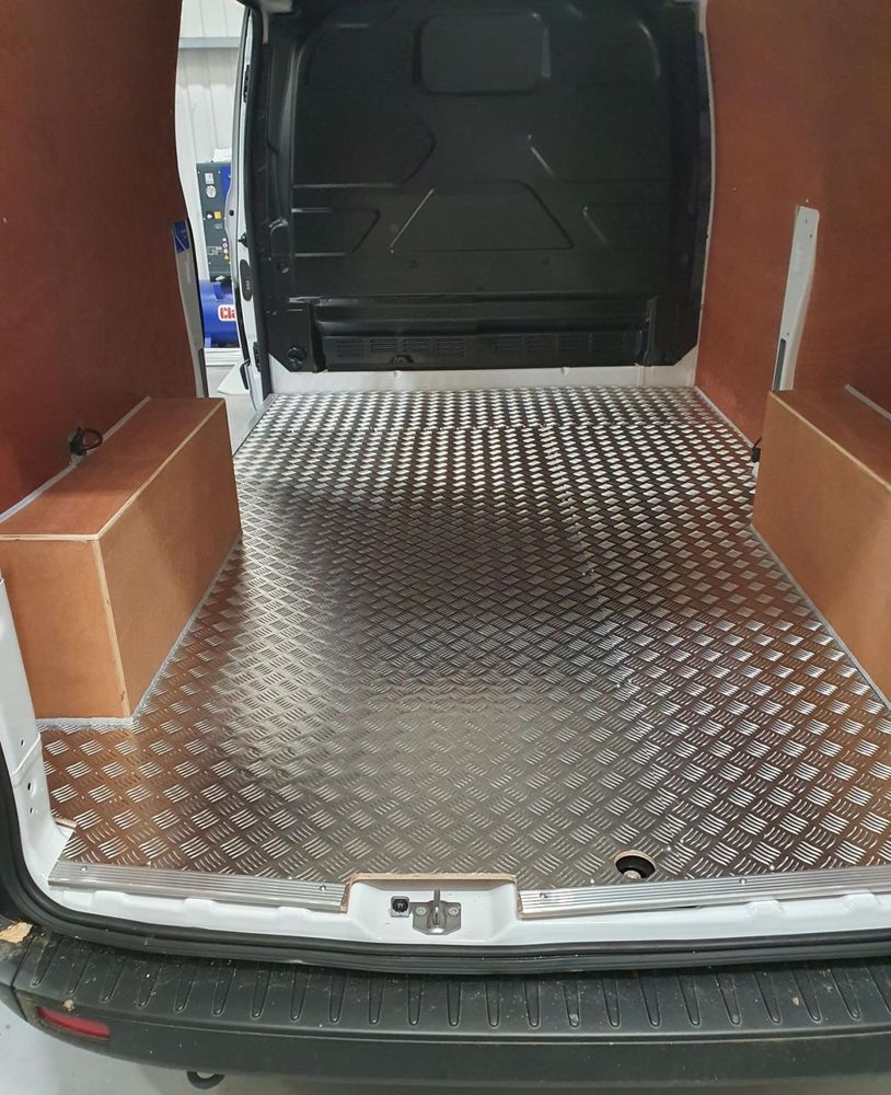 Finished checker-plate floor lining in a van load area