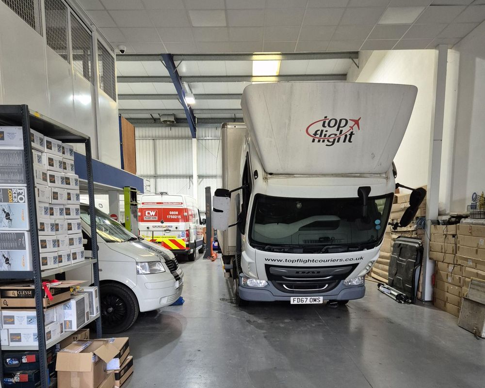 A Luton box van and a panel van part-way through fit-out